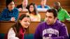 Students sitting and talking on lecture theatre benches in a university