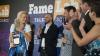 FameLab 2018 winner smiling with award surrounded by members of the jury and keynote speaker clapping.